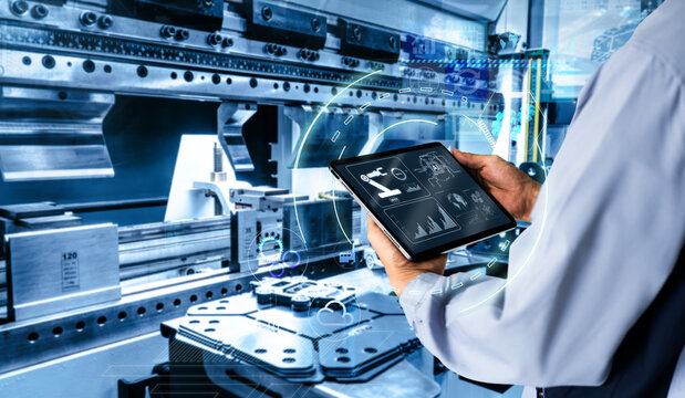 Smart industry control concept.Hands holding tablet on blurred automation machine as background