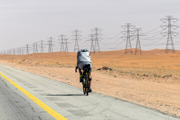 Cyclist with a saddle bag near Qatar Saudi border. Traveler on bicycle on sunny day