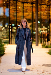 Fototapeta premium Full length of beautiful female walking in the city in an autumn day