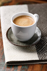 Cup of coffee on wooden background. Soft focus.