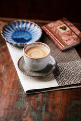 Cup of coffee on wooden background. Soft focus.