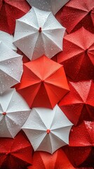 Abstract composition of red and white umbrellas with water droplets creating a bold and dynamic pattern