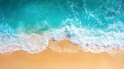 Aerial view of turquoise ocean waves crashing on a sandy beach.
