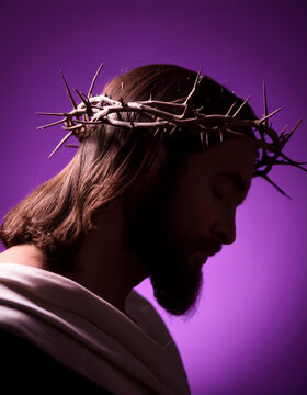 Silueta a contraluz de nuestro se&ntilde;or Jesucristo con la corona de espinas durante la pasi&oacute;n, Sobre fondo morado. Concepto de cuaresma y creencia en la fe cat&oacute;lica