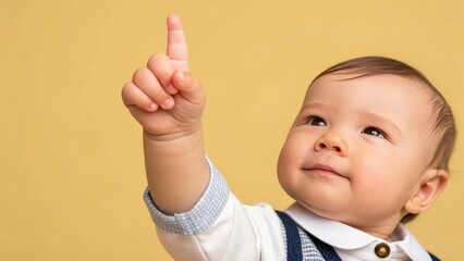 a cute baby points up at something with a look of wonder. The child's gesture captures the moment of discovery and curiosity, and the image is soft and warm