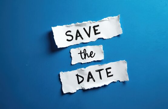 Save the date message on white ripped paper pieces. Blue background with copy space. Reminder of schedule, invitation for party. Conceptual announcement. Top view shot.
