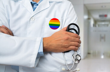 Close-up of heart silhouette with lgbt flag of doctor in white coat with stethoscope and LGBT badge...