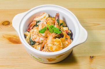 Thai basil stir-fried with king prawns and eryngii mushroom Thai food on the wood table