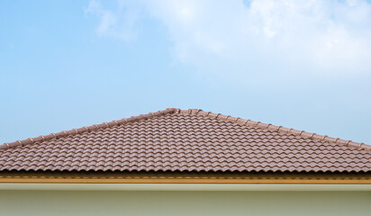 Roof with textured tiles against a blue sky