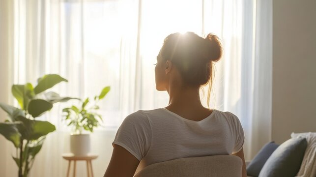 Shoulder stretch in a calming home environment with soft furnishings. Featuring relaxation and rejuvenation