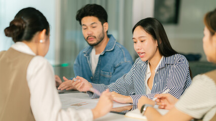 Fototapeta premium Collaborative business meeting with diverse professionals discussing ideas. Engaged individuals share insights in modern office setting, fostering teamwork and innovation. Leader Teamwork stratup