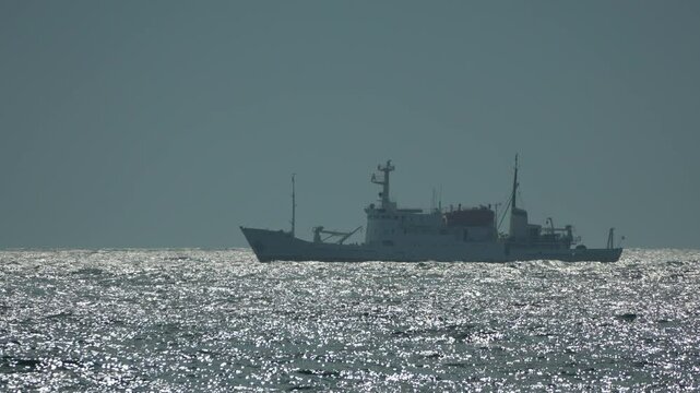 Ship Ocean Sea - A silhouette of a ship sailing on the ocean during a cloudy day. - Powered by Adobe