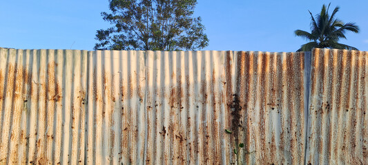 Old zinc vintage fence wall texture for background, pattern of rusty on metal panel.Tin Roof wall countryside