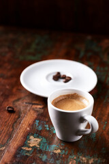 Cup of coffee on wooden background. Soft focus.