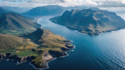 Obraz premium Aerial Landscape View of Mountains and Rugged Coastline Showcasing Dramatic Scenery and Natural Beauty Overlooking the Ocean.