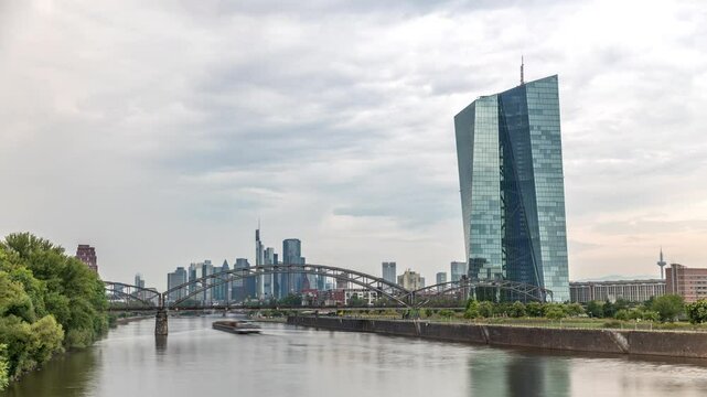 Hyperlapse of Frankfurt skyline featuring the modern ECB headquarters skyscraper with reflective steel-glass facade, train arch bridge and rain clouds in the sky timelapse. Frankfurt am Main, Germany