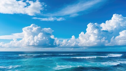 Serene Ocean Waves Under a Bright Blue Sky with Soft White Clouds and Reflective Deep Blue Sea Water.