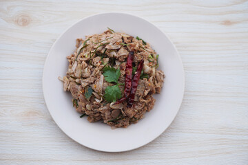 Homemade spicy young jackfruit salad, mixed with herbal food ingredient, serve in dish. Concept, local traditional food in Thailand. Delicious healthy menu. Top view.     