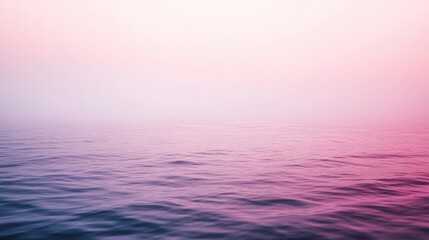 Obraz premium A serene gradient of soft pink and purple hues blend over calm waters, creating a peaceful atmosphere at dawn or dusk.