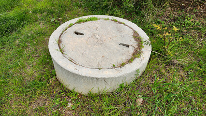 A concrete lid covers the sewage system, providing a sturdy and durable barrier to protect the underground infrastructure from external elements