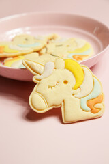 Thin homemade biscuits in unicorn shape. Sugar cookies for children, birthday party, Easter or baby shower.