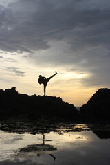 silhouette of a man jumping on the beach
