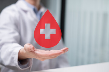 Professional health care worker doctor physician holding blood icon for blood donation concept