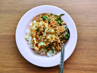 Steamed jasmine rice topped with stir-fried minced pork with holy basil and a crispy fried egg.