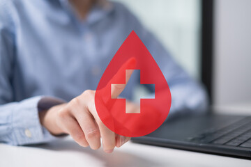 Professional health care worker doctor physician holding blood icon for blood donation concept