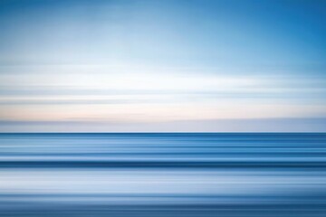 Obraz premium Serene Seascape with Soft Waves Under a Calm Sky at Dusk