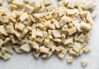 Nigerian Chin chin dough on a white granite countertop, Raw sliced chin-chin on a chopping board, process of making chin chin achomo or klenat
