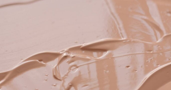 Liquid make up foundation or concealer cosmetic texture close up. Beauty abstract