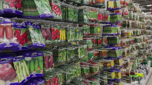 Flower and plant seeds: vegetables and fruits in the supermarket. Sale of plants, flowers, seeds, fertilizers, everything for the garden. A variety of seeds in bags