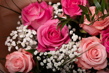 Romantic pink roses and delicate baby's breath create a stunning bouquet. Perfect for...