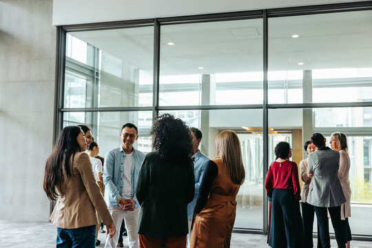 Business professionals networking in modern office setting - Powered by Adobe