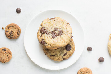 Overhead view of chocolate chip cookies on white plate, top view of homemade chocolate chip cookies on a white background