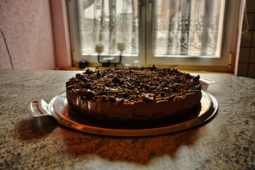 Chocolate cake on a plate in a kitchen