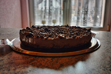 Chocolate cake on a plate in a kitchen