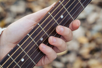 Playing long time the guitar, prints of strings on fingers. Close up of hand of guitarist woman...