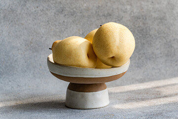 Elegant display of Chinese white pears in ceramic bowl
