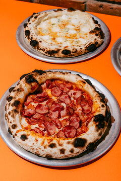 Four Meats and Four Cheese Pizzas with Rich Toppings