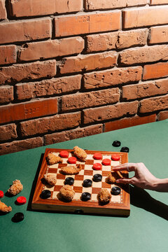Checkerboard Game with Chicken Nuggets on Rustic Brick Background