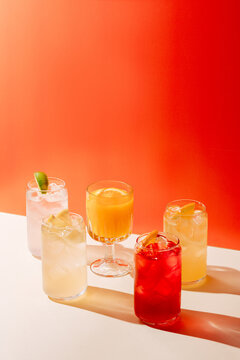 Assorted Lemonades Against Vibrant Orange Background