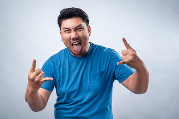 Fototapeta premium An Asian man in a blue t-shirt makes the 