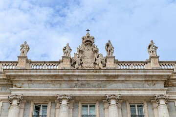 Madrid, Spain - october 02, 2024: Facade of the Royal Palace of Madrid with tourists walking around in Madrid, Spain