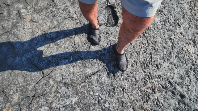 Tourist enjoying a walk on the therapeutic mud of the pink salty sasyk sivash lake in crimea