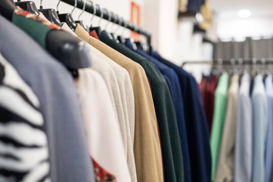 Close up of colorful clothes on hangers in a suit store
