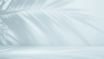 Blurred shadow from palm leaves on the light blue wall. Minimal abstract background for product presentation. Spring and summer.
