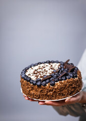 delicious chocolate cake with candles and blueberries for a holiday or birthday.