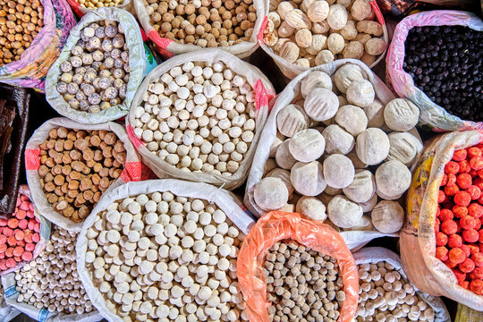Bags with various types of traditional dried salted cheese, known as kurut in Kyrgyz, kurt in Kazakh, and kurtob in Uzbek, at a market in Central Asia.